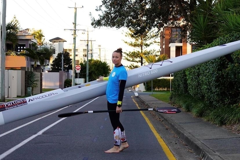 woman holding surf ski 