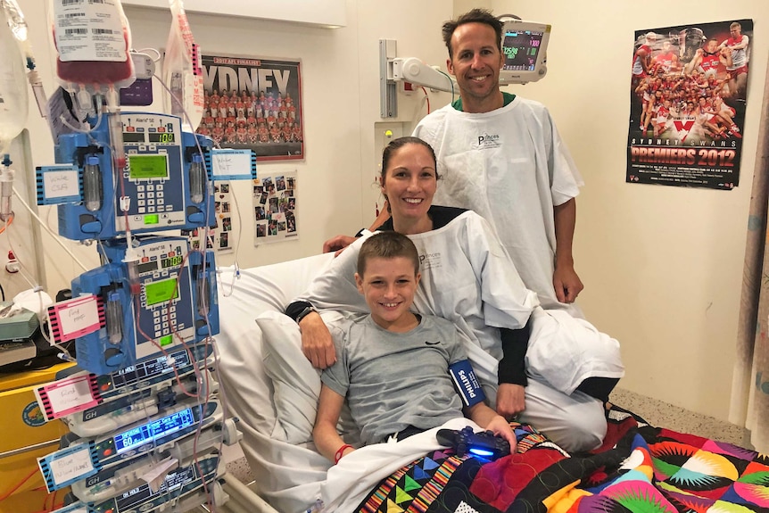 Hayden Smith in hospital with parents Belinda and Chris McTaggart.