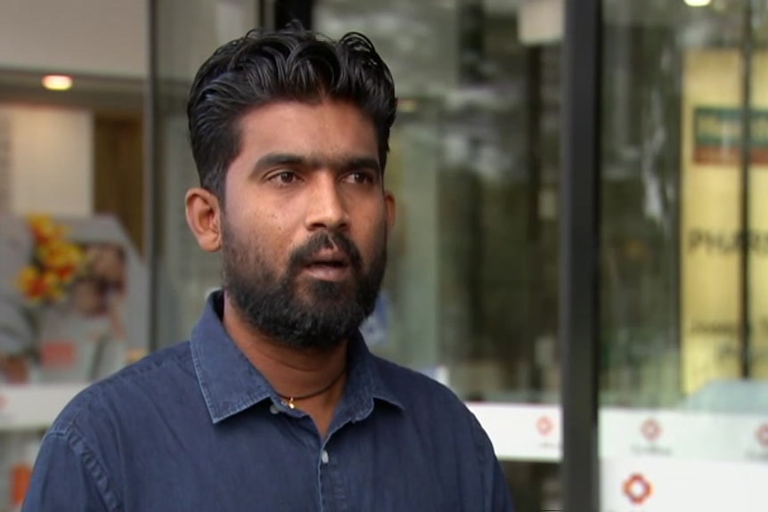 Vasantharaj Vasanthakumar speaks while standing outside The Alfred hospital in Melbourne.