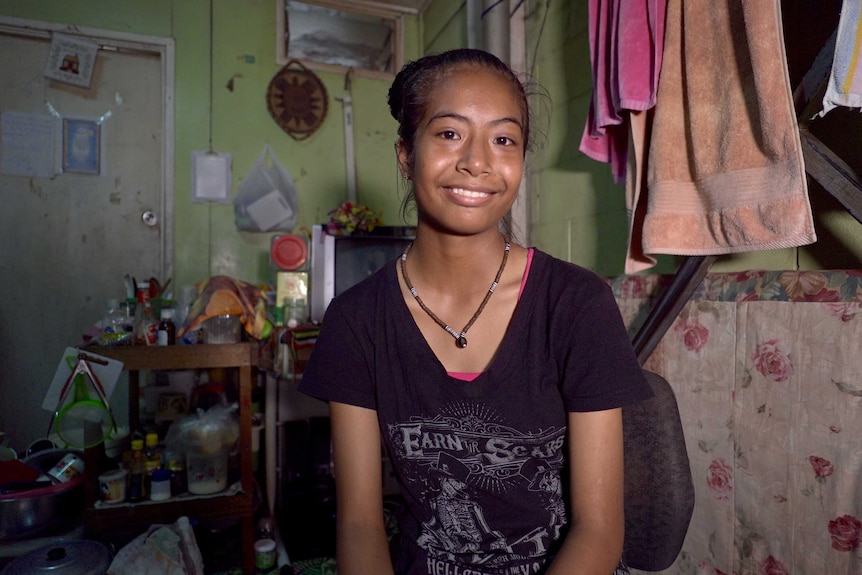 Fourteen-year-old Vuina Guria sits in her bedroom in Port Moresby, Papua New Guinea.