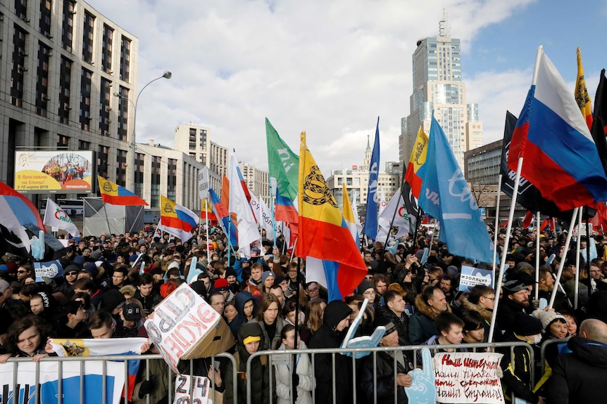 Scores of protesters are seen holding banners to protest against proposed Internet changes