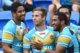 Titans players celebrate a try against the Raiders