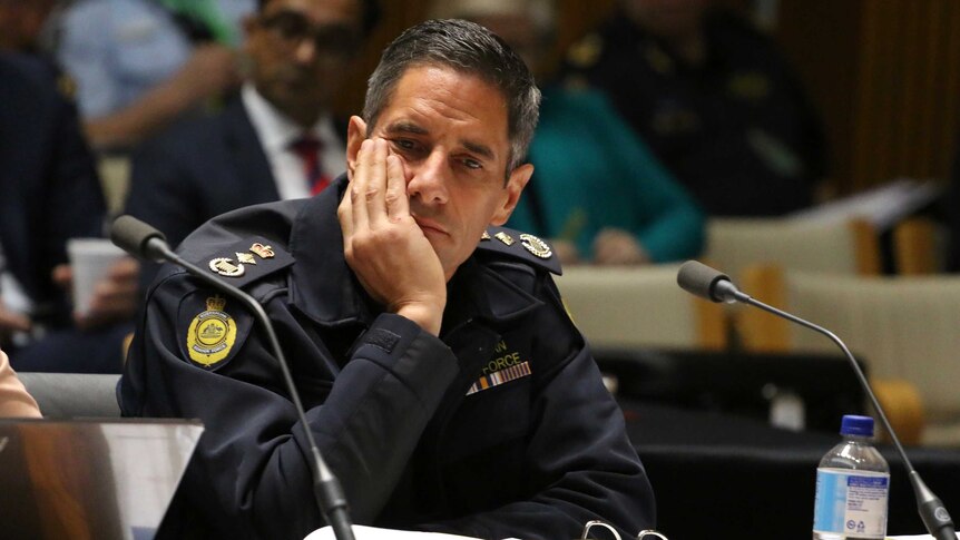 Border Force Commissioner Roman Quaedvlieg leans his head on his hand.