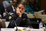 Border Force Commissioner Roman Quadvlieg leans his head on his hand.