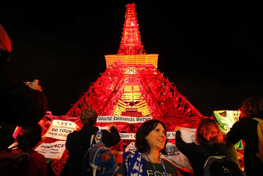 People demonstrate in front of replica Eiffel Tower at COP21
