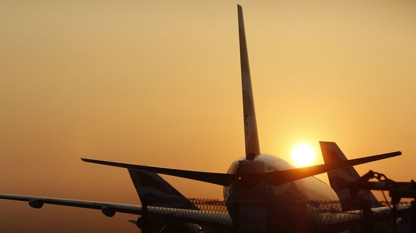 Grounded: The sun sets behind planes at Heathrow airport