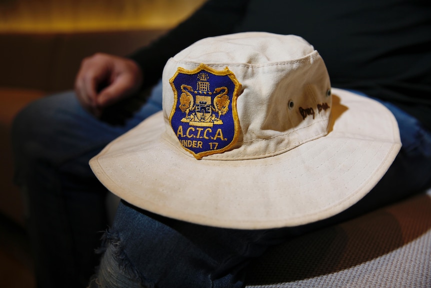 A white, wide brimmed hat with an ACT logo attached to it.