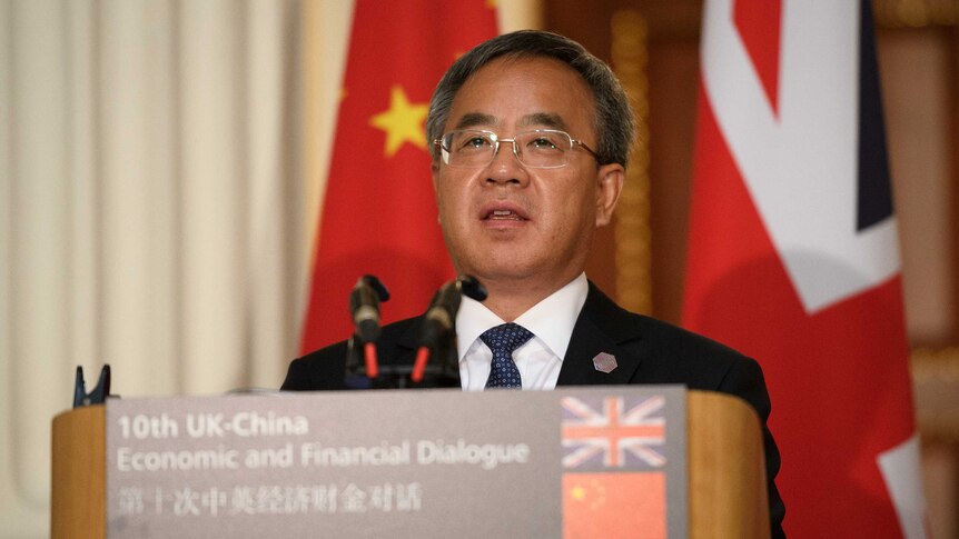 China's Vice Premier Hu Chunhua speaking at a podium.
