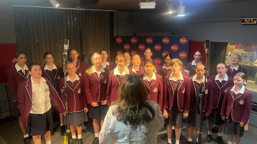 School choir performing in a radio studio.