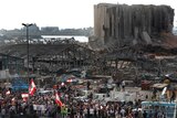 People gather in honour of the victims at the scene of last week's explosion in Beirut.
