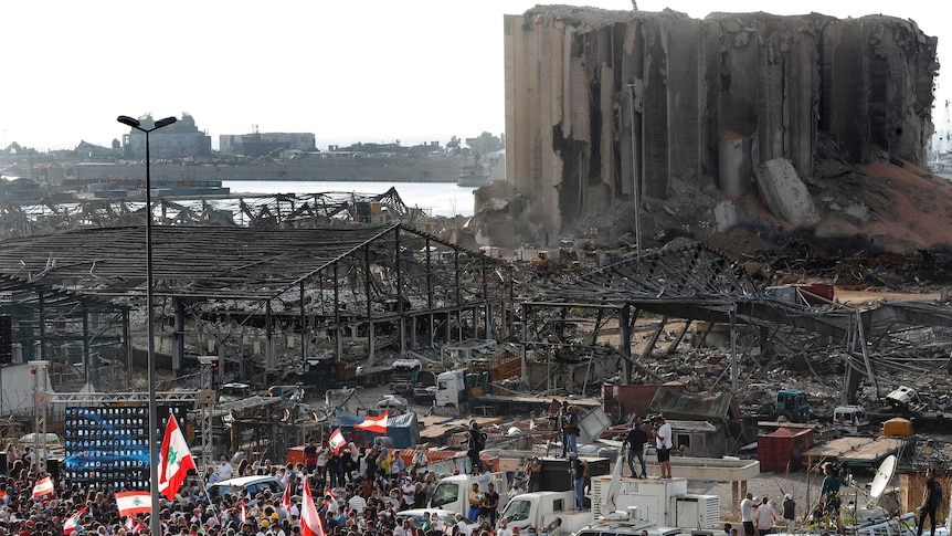 People gather in honour of the victims at the scene of last week's explosion in Beirut.