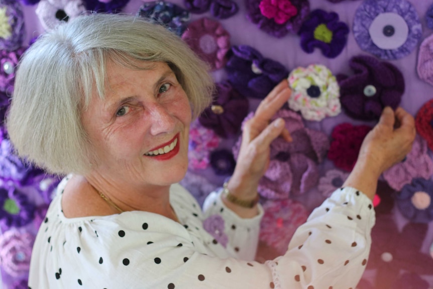 Judy Joukador touches a piece of the "purple road".