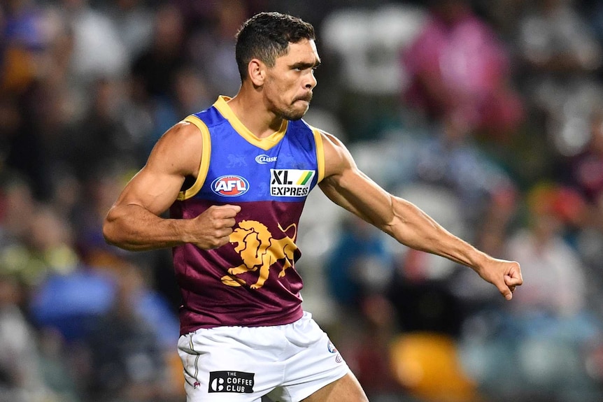 A Brisbane Lions AFL player performs a celebration after kicking a goal against the Sydney Swans.