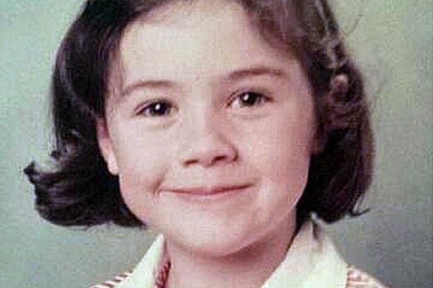 A young girl grins in a portrait shot.