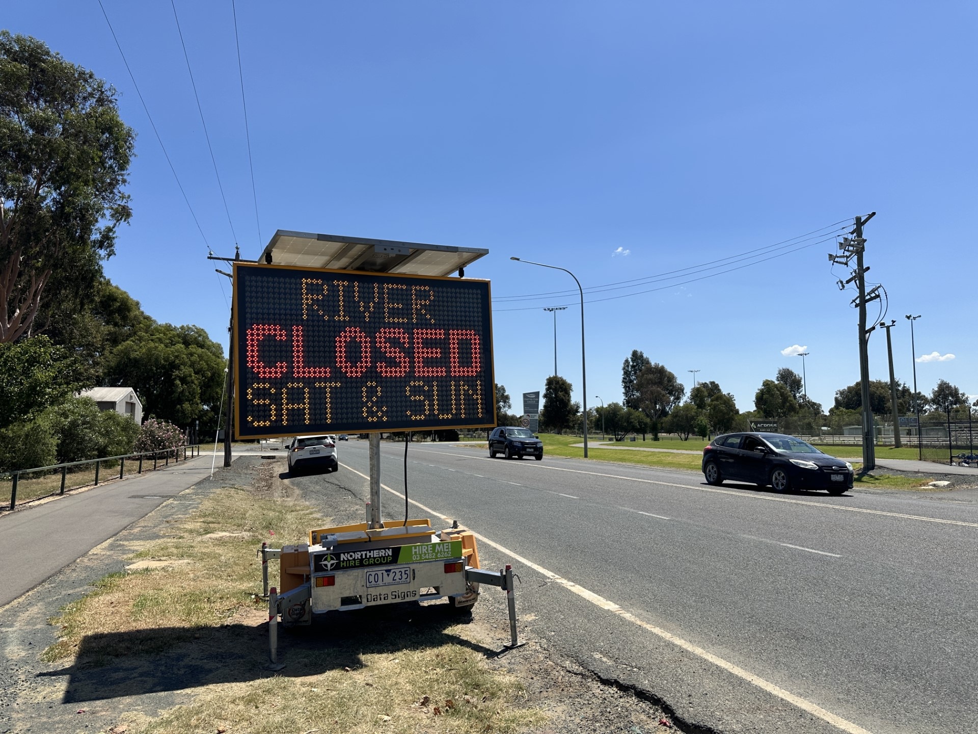 A road sign that reads "river closed sat and sun"