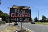 A road sign that reads "river closed sat and sun"
