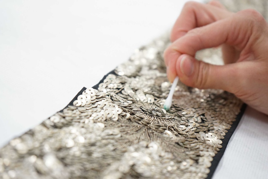 Sequins are cleaned using cotton wool.