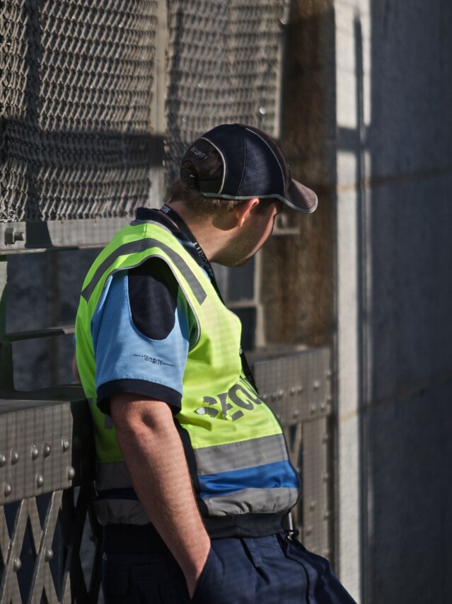 A security guard watches over the Sydney Harbour Bridge