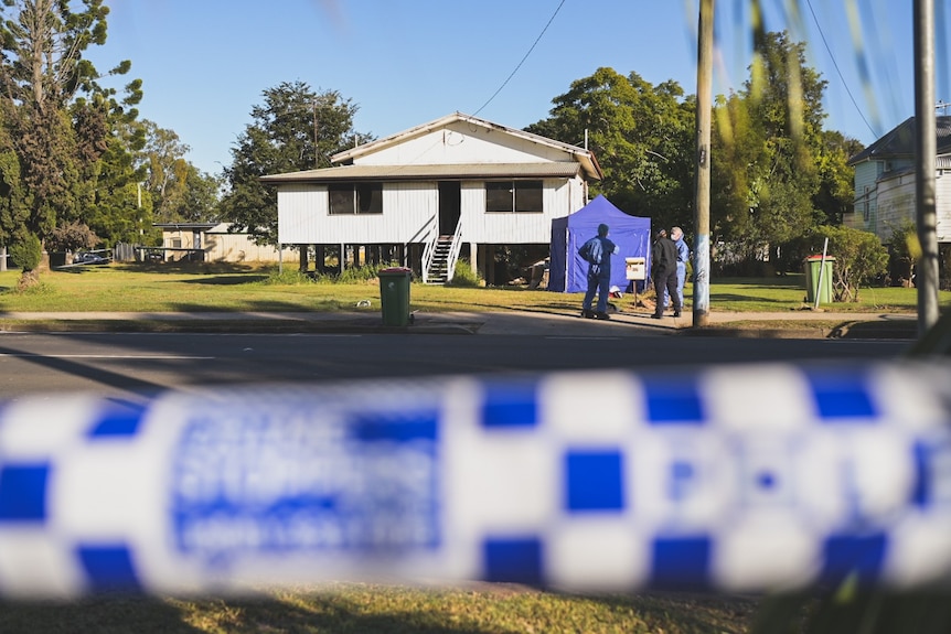Police at scene of man's death in Laidley, with blue tent out the front and officer in blue suit