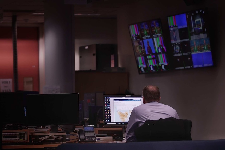 A man in a TV control studio