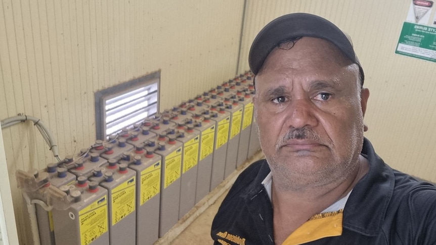 A selfie of Tony Jack in front of a solar battery.