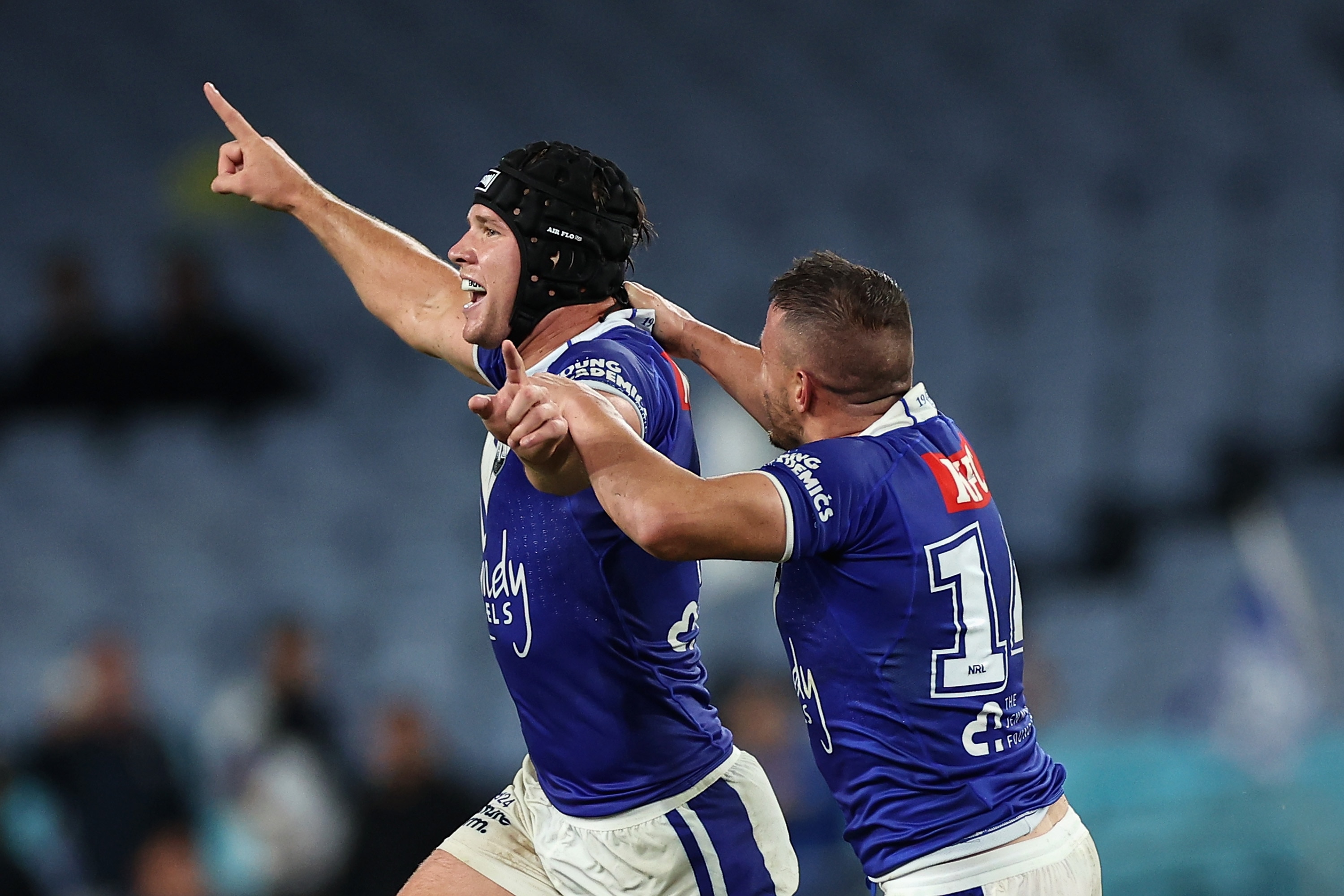 Two Canterbury NRL players celebrate winning a match against North Queensland.