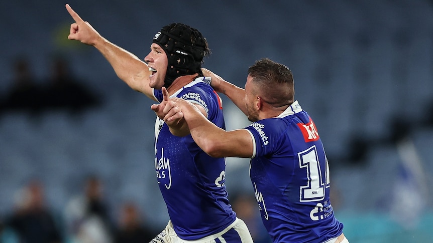 Two Canterbury NRL players celebrate winning a match against North Queensland.