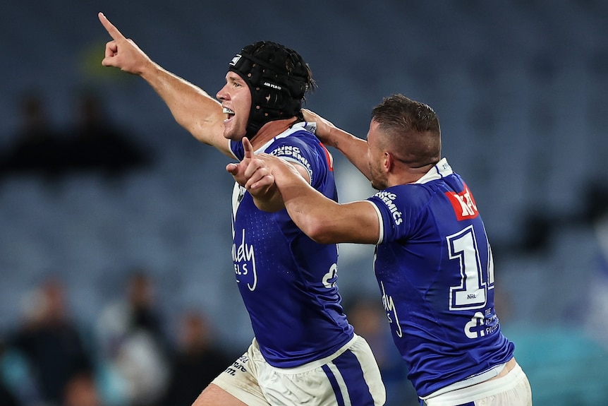 Two Canterbury NRL players celebrate winning a match against North Queensland.