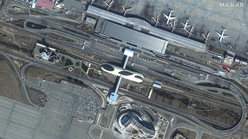 Satellite imagery shows Tehran airport, including a mostly empty carpark.