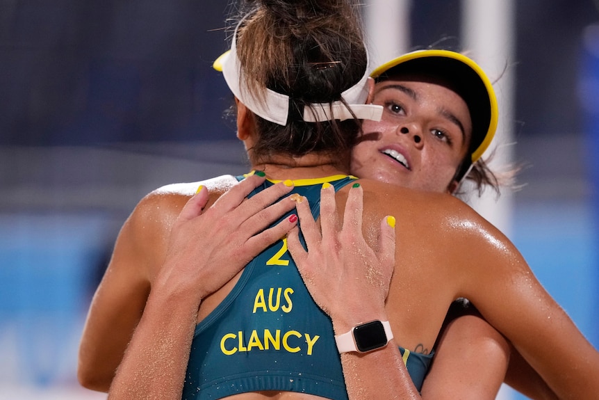 Two Aussie beach volleyballers hug afte