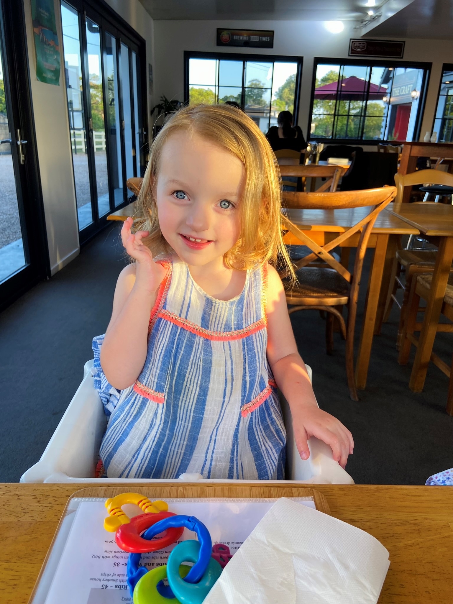 A little girl in a pretty dress smiling for the camera