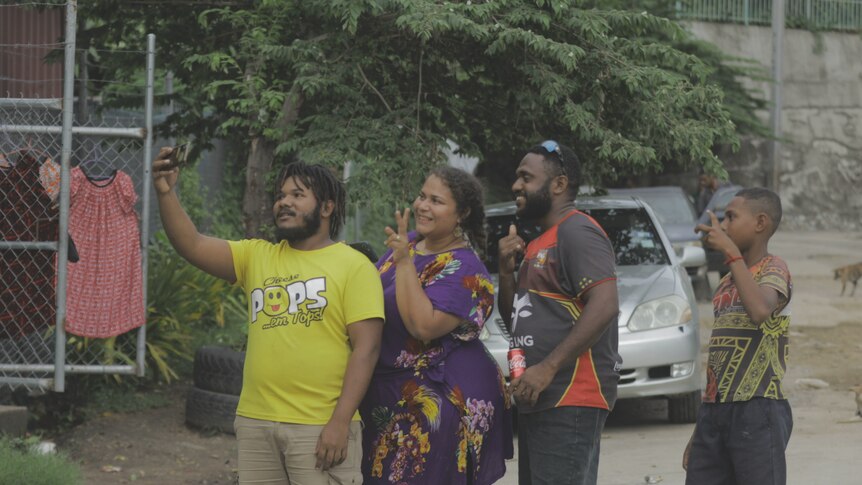 PNG singer Danielle poses for a photo with fans on the street's of Port Moresby