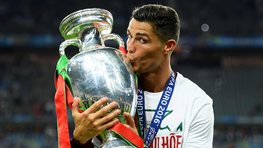 Cristiano Ronaldo kisses the Euro trophy