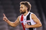 A St Kilda AFL player points the index finger on his right hand as he celebrates kicking a goal against Carlton in Melbourne.