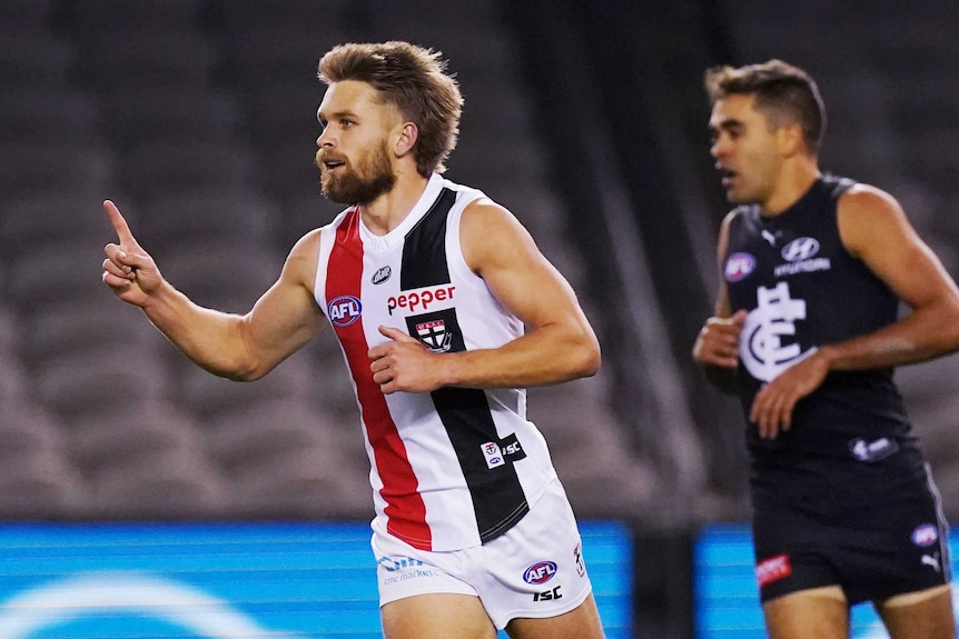 A St Kilda AFL player points the index finger on his right hand as he celebrates kicking a goal against Carlton in Melbourne.