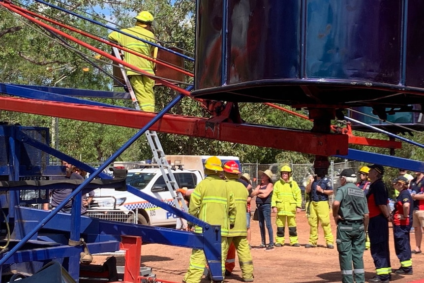 Firefighters work to remove children stuck in a ride at the Freds Pass Show.