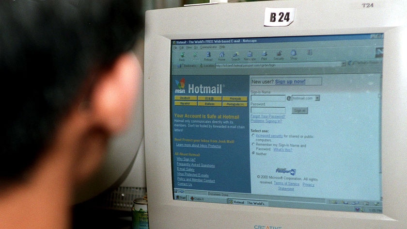 An unidentifiable man checks his hotmail email account in an internet cafe