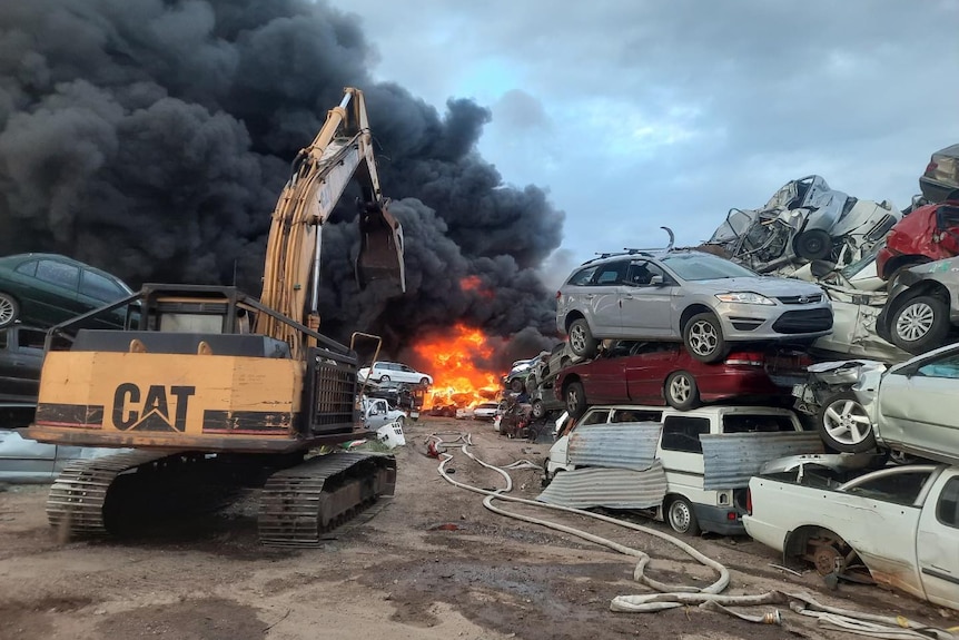 Close up shot of pile of cars on fire