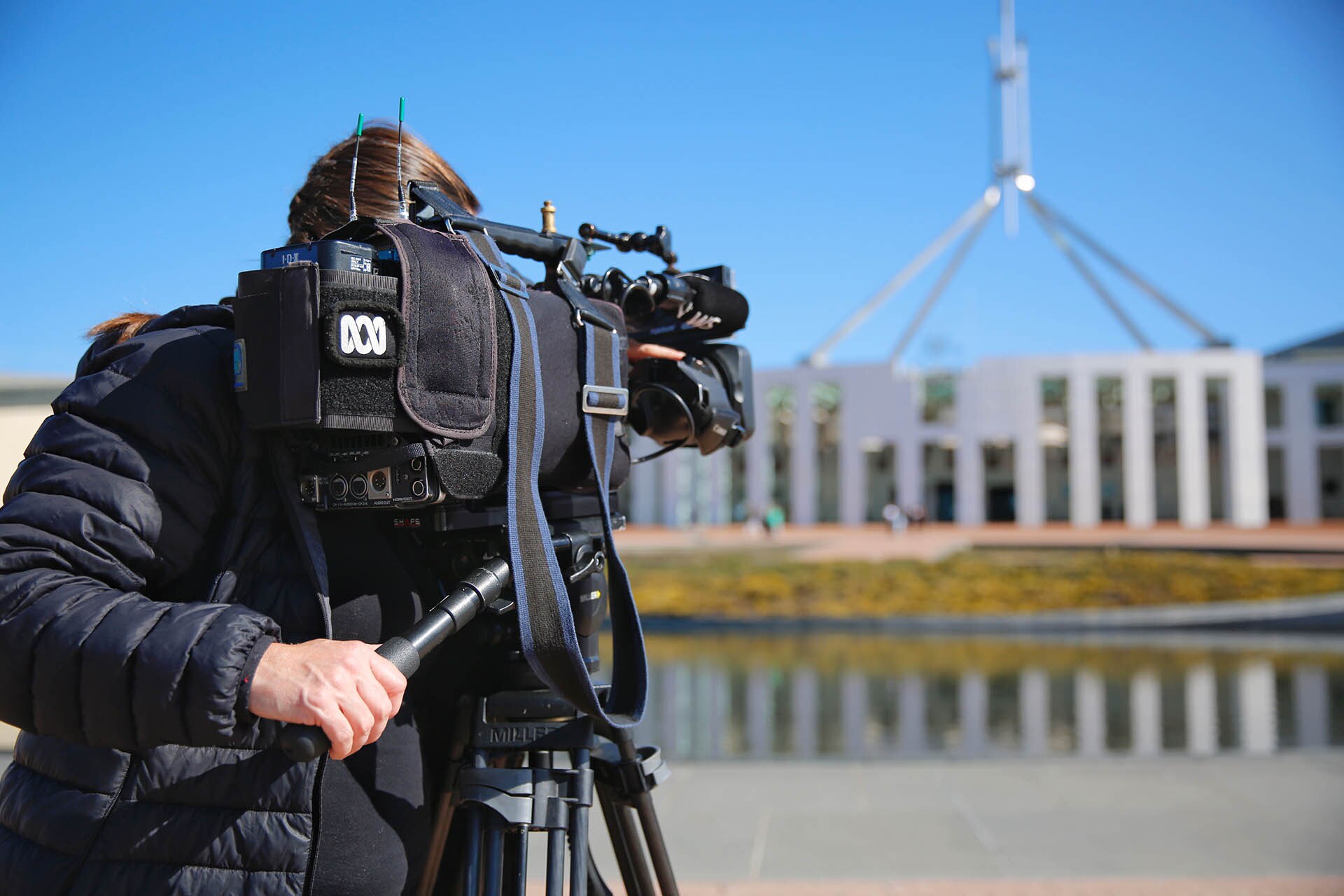 ABC camera operator filming Parliament House