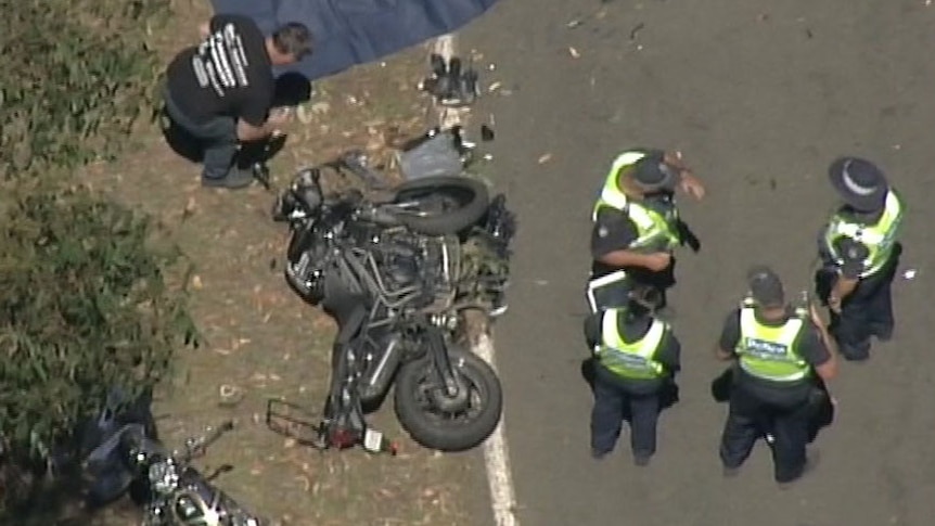 Police standing around a crashed motorcycle on the road near Marysville.