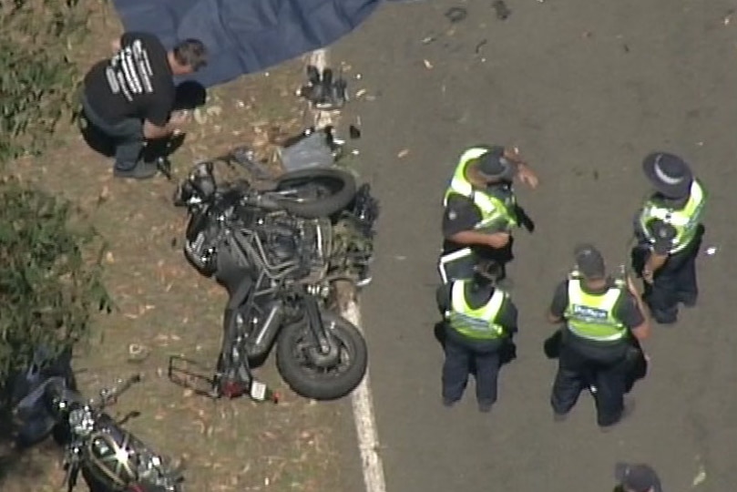Police standing around a crashed motorcycle on the road near Marysville.