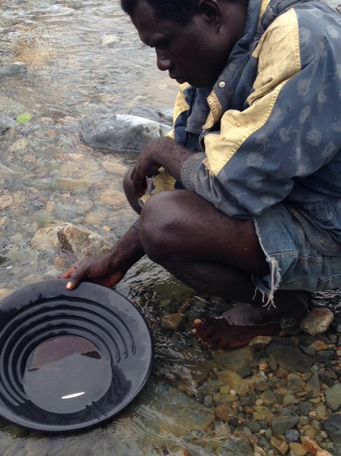 A man sifts for gold dust in Bougainville, PNG.