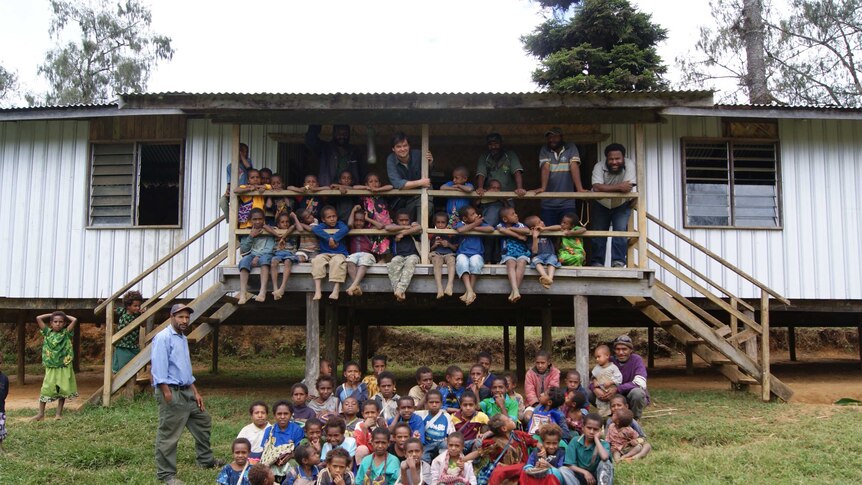 Children and teachers around a school.