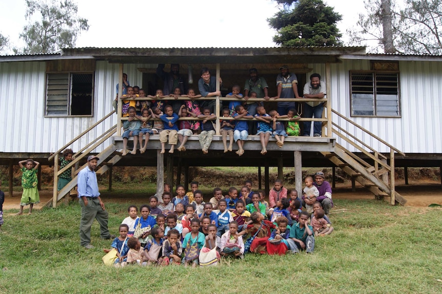 Children and teachers around a school.