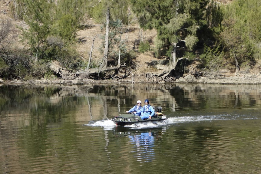 Weed contractors Christina Bariesheff and Jim Bariesheff take the amphibious vehicle for a spin at Kambah Pool.