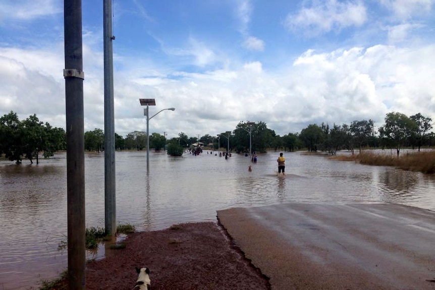 People wade through flood water in Beswick