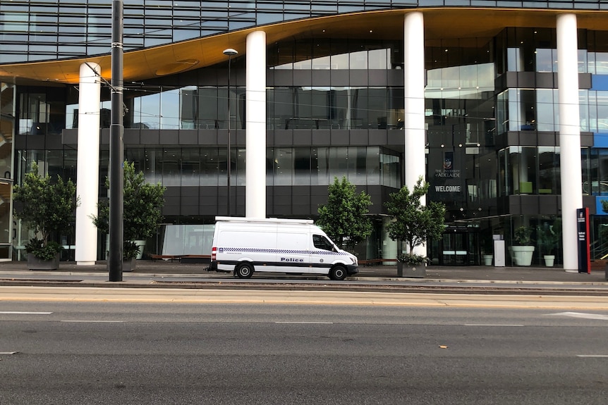 A police van outside a large building