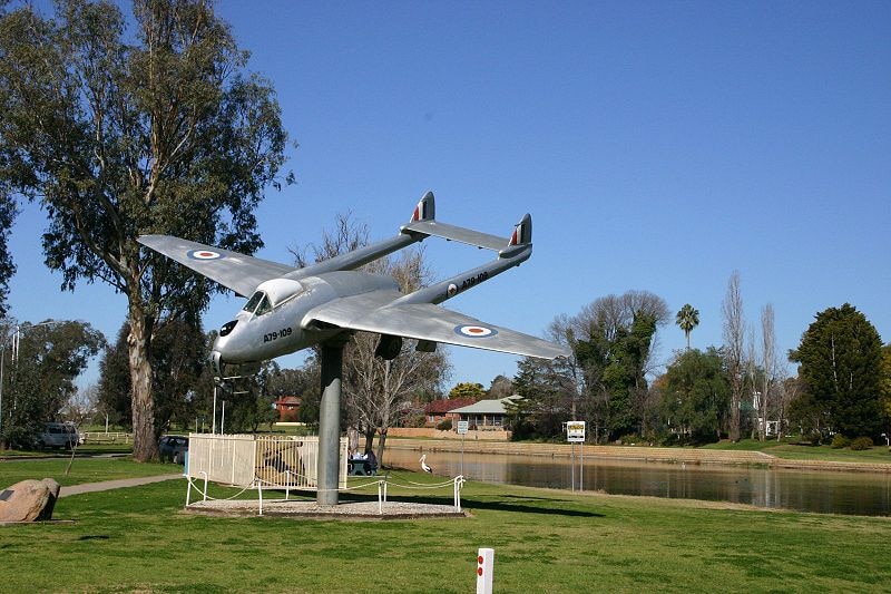forbes vampire jet sitting on pole next to Lake Forbes
