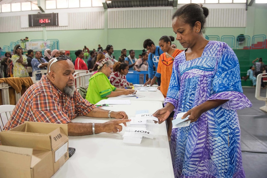 Woman stands at a polling station