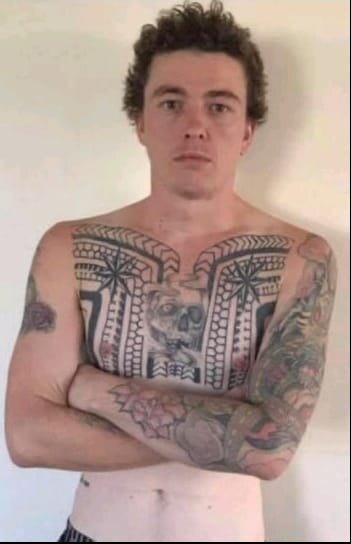 Man staring at camera with his arms crossed.